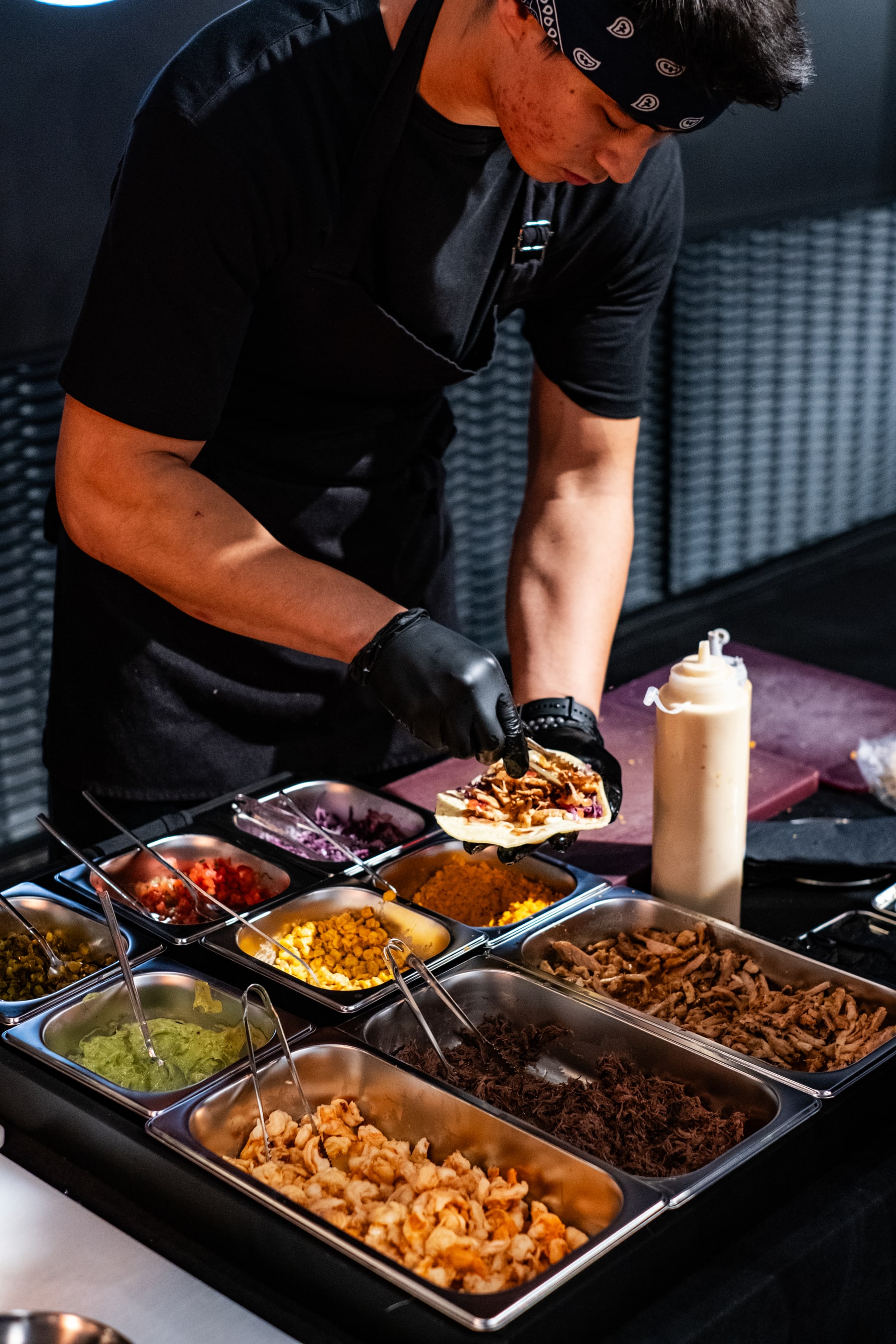 Good Catering chef preparing a dish at an open station